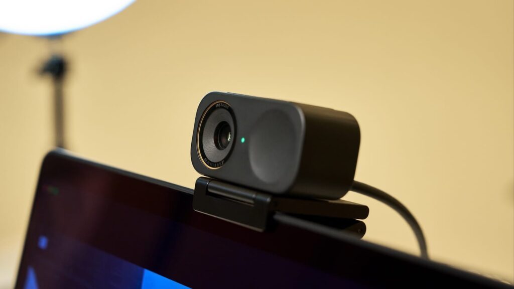 A person using the Insta360 Link webcam for a video call