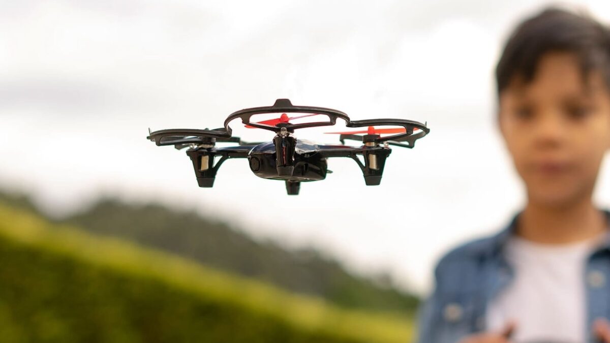 A family happily playing with a drone outdoors